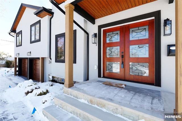 view of snow covered property entrance