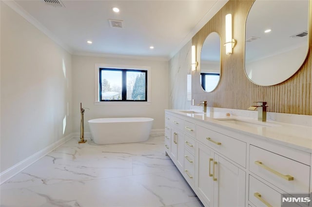 bathroom featuring crown molding, a tub, and vanity