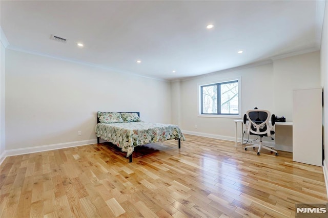 bedroom featuring light hardwood / wood-style floors and ornamental molding