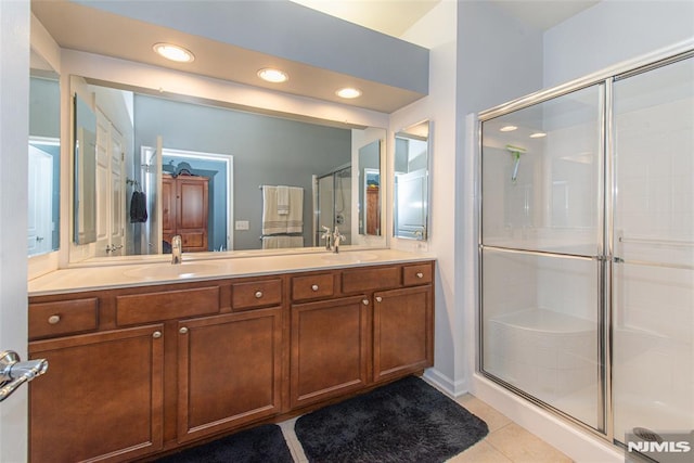 bathroom featuring tile patterned floors, walk in shower, and vanity