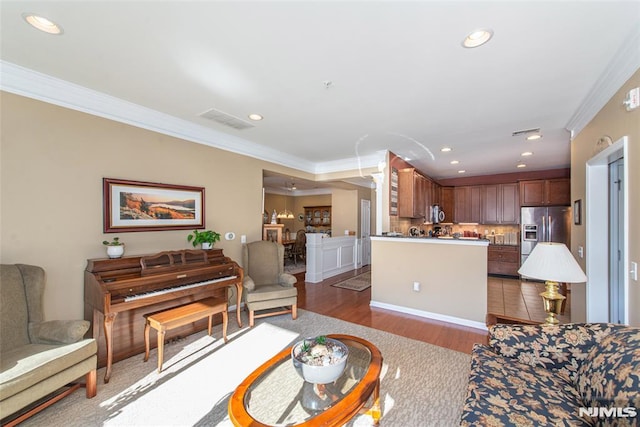 living room with crown molding and dark hardwood / wood-style flooring