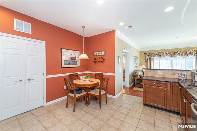 tiled dining space with ornamental molding