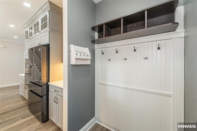 mudroom featuring light hardwood / wood-style flooring and ornamental molding