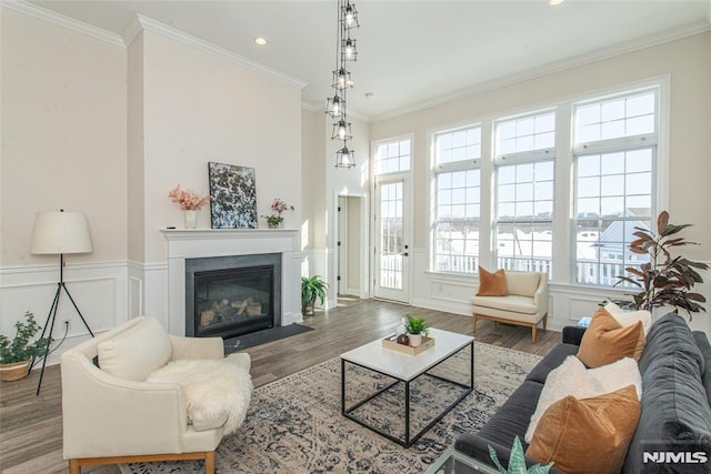 living room with ornamental molding and wood-type flooring