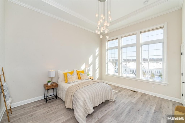 bedroom with ornamental molding, a notable chandelier, and light wood-type flooring