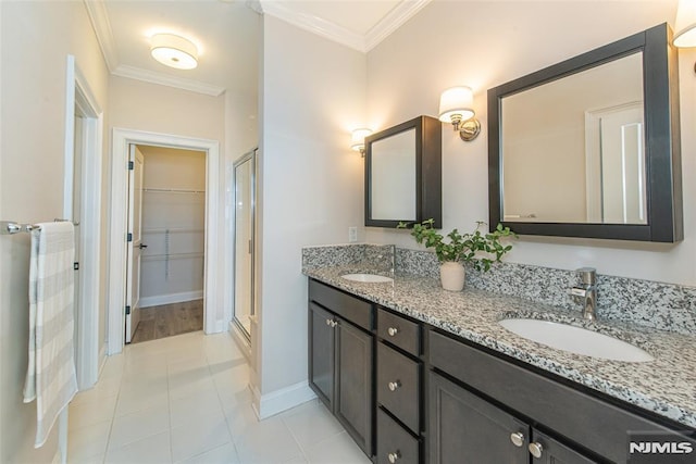 bathroom with tile patterned flooring, crown molding, a shower with door, and vanity