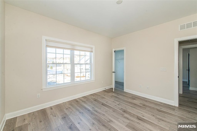 spare room with light wood-type flooring