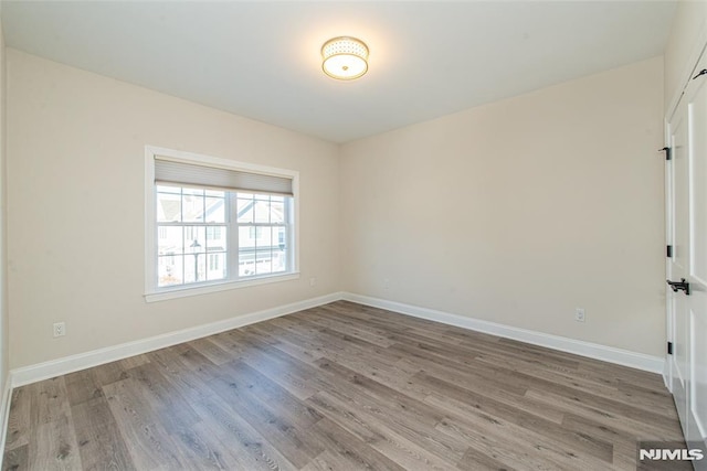 spare room with hardwood / wood-style floors