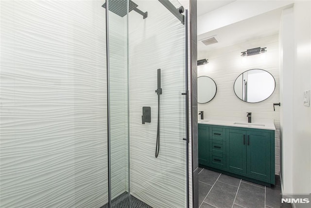 bathroom featuring tile patterned flooring, vanity, and a shower with door