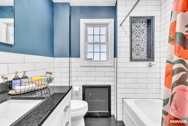 full bathroom featuring toilet, radiator, tile walls, tile patterned floors, and vanity