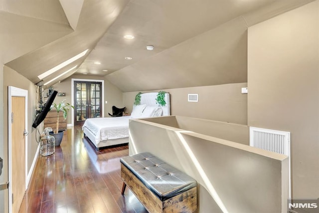 bedroom with french doors, dark hardwood / wood-style floors, and lofted ceiling