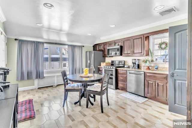 kitchen with sink, crown molding, decorative backsplash, and stainless steel appliances