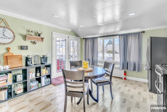 dining room with vaulted ceiling, french doors, and crown molding