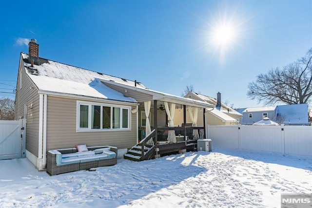 snow covered property with a wooden deck