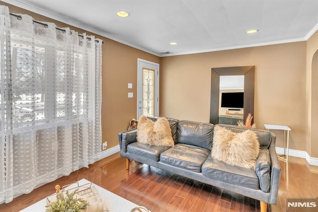 living room with crown molding and hardwood / wood-style floors