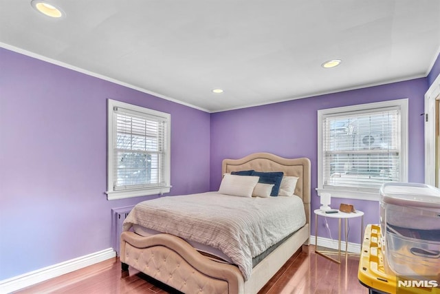 bedroom with hardwood / wood-style flooring and ornamental molding