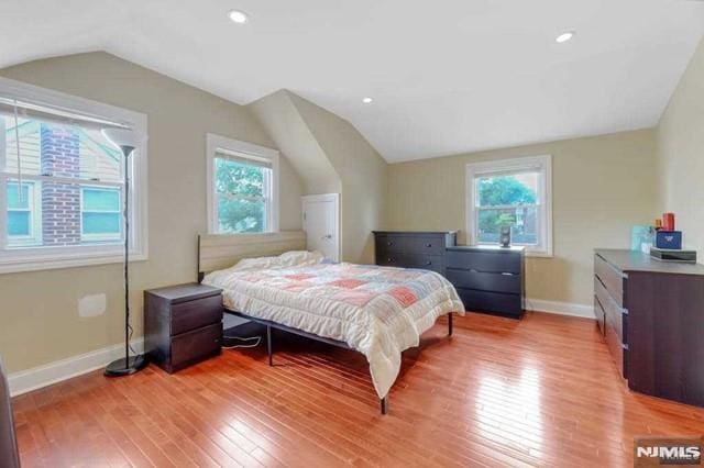 bedroom with light hardwood / wood-style flooring and vaulted ceiling