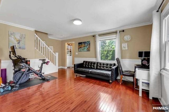 living room featuring hardwood / wood-style flooring and crown molding