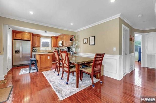 dining space featuring hardwood / wood-style floors and crown molding