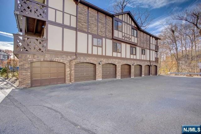 view of property exterior featuring stucco siding and brick siding