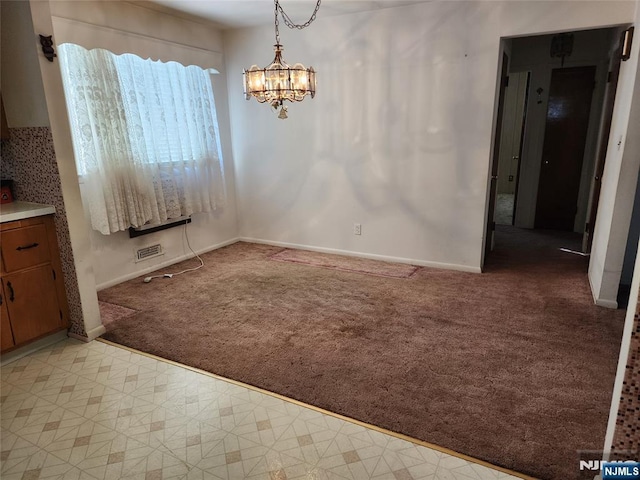 unfurnished dining area with light carpet and an inviting chandelier