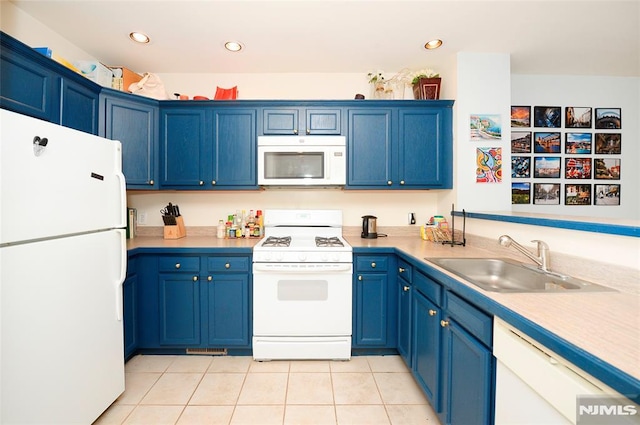 kitchen with sink, blue cabinets, white appliances, and light tile patterned flooring