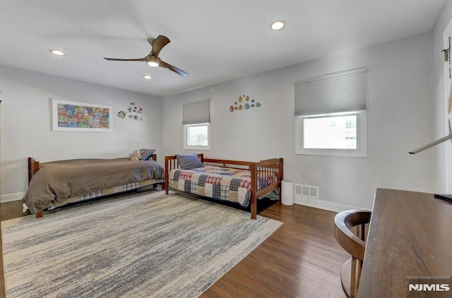 bedroom with ceiling fan and dark hardwood / wood-style flooring