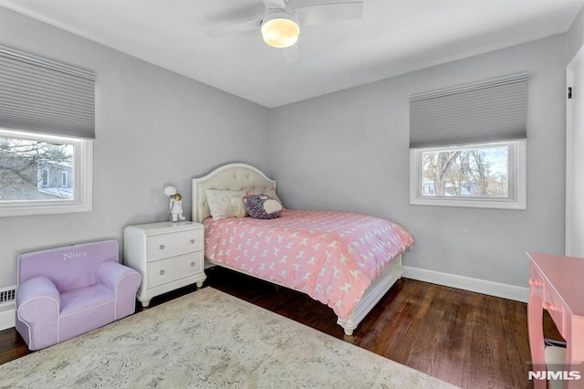 bedroom with ceiling fan and dark hardwood / wood-style floors