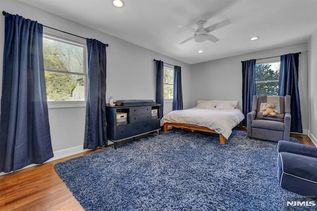 bedroom with ceiling fan and hardwood / wood-style floors