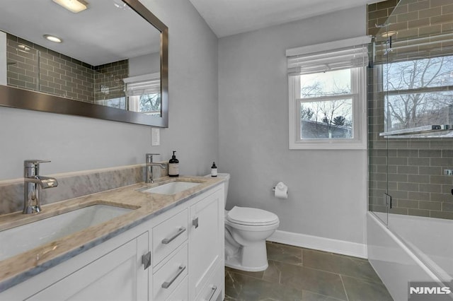 full bathroom with toilet, tile patterned floors, enclosed tub / shower combo, and vanity