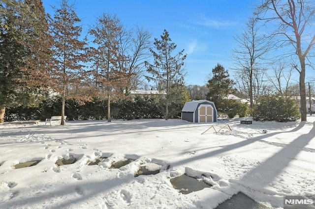 yard covered in snow with a storage unit