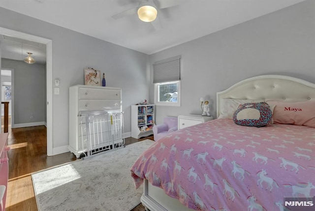 bedroom with ceiling fan and dark hardwood / wood-style floors