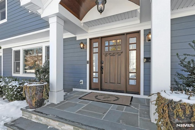 view of snow covered property entrance