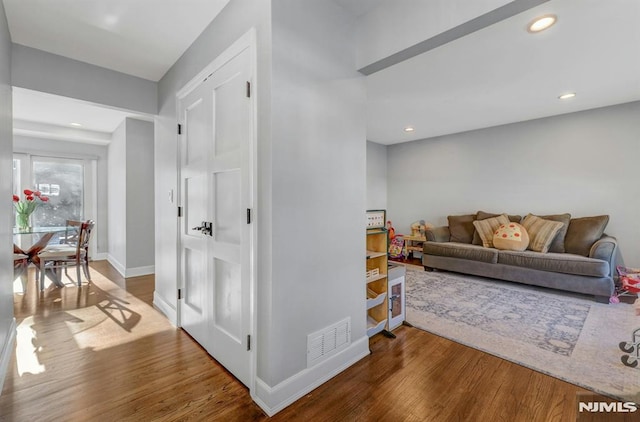 corridor with hardwood / wood-style floors