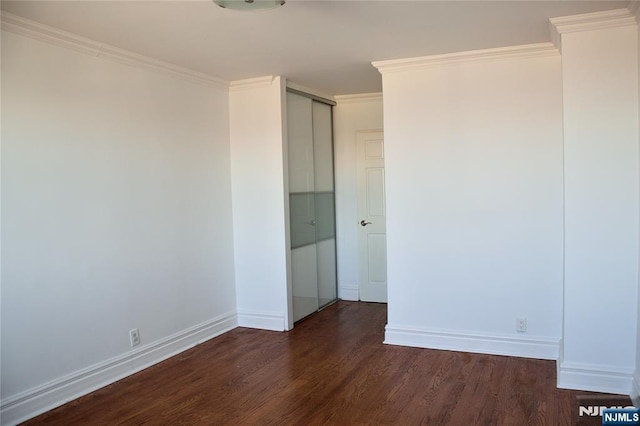 unfurnished bedroom featuring dark hardwood / wood-style flooring and crown molding