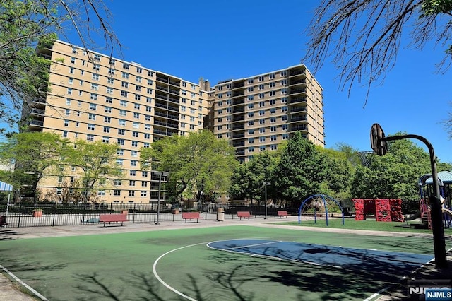 view of basketball court with a playground