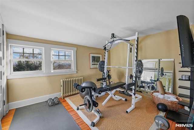 workout room featuring hardwood / wood-style flooring and radiator