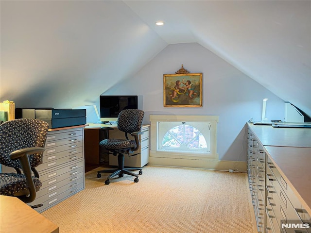 carpeted home office with lofted ceiling