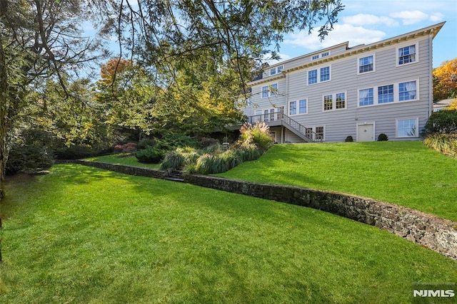 rear view of property featuring a lawn