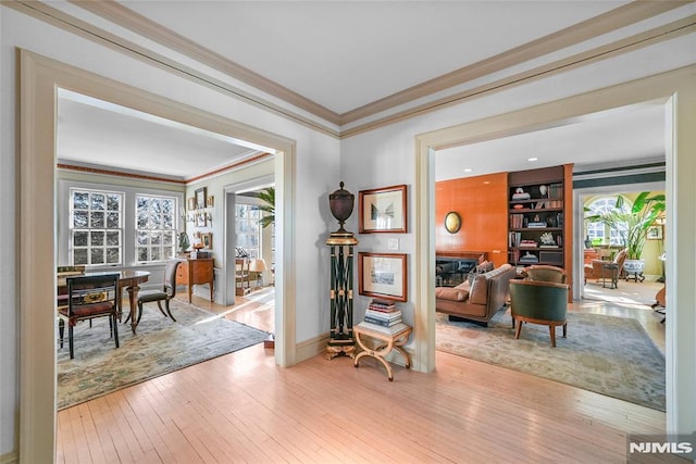 sitting room featuring crown molding and light hardwood / wood-style floors