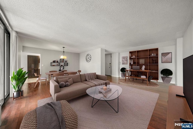 living room featuring dark hardwood / wood-style flooring and a textured ceiling