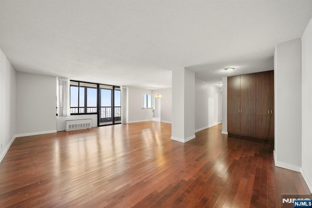 empty room with dark hardwood / wood-style flooring