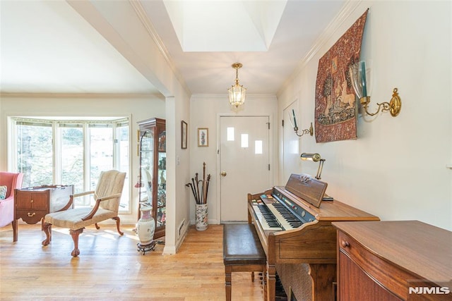 entryway featuring light wood-type flooring and ornamental molding