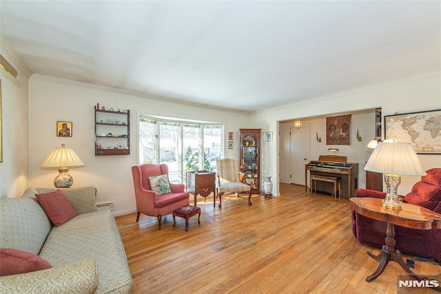 living room with wood-type flooring, a baseboard heating unit, and crown molding