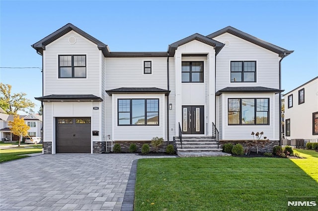 modern inspired farmhouse featuring cooling unit, a garage, and a front lawn