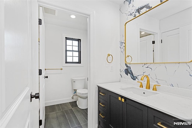 bathroom featuring backsplash, toilet, and vanity