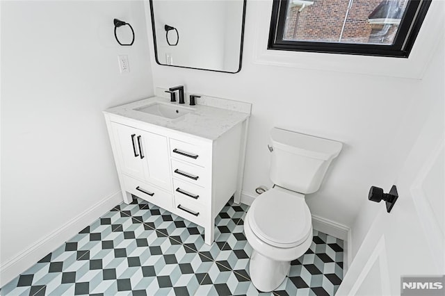 bathroom featuring toilet and vanity