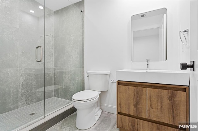 bathroom featuring vanity, toilet, a shower with door, and tile patterned flooring