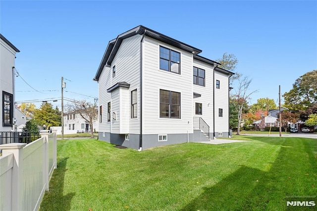 rear view of property with a lawn