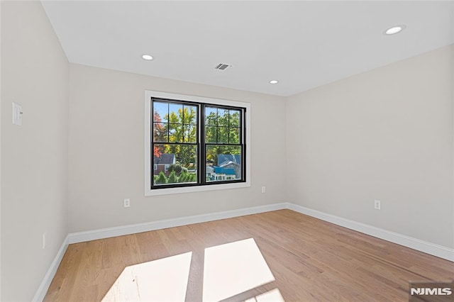 spare room featuring light hardwood / wood-style floors